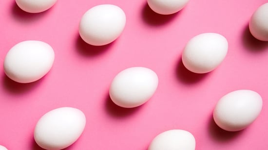 white eggs on pink background