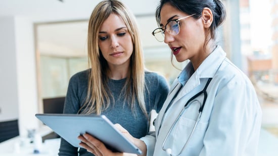 fertility doctor with new female patient explaining treatment plan