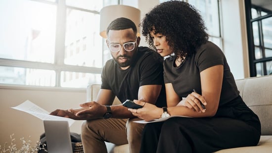 a black couple takes a fertility quiz sitting on couch