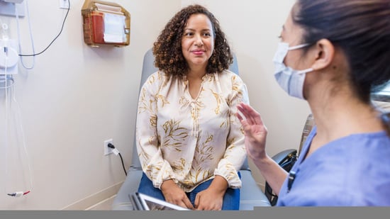 40 year old woman discussing fertility with nurse at doctor's office