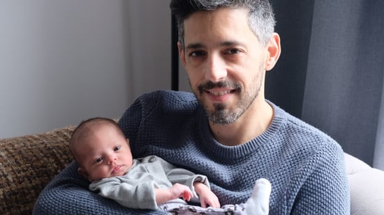 single parent surrogacy story father holding newborn daughter