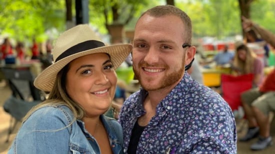 a man and woman smile at the camera